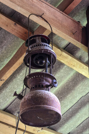 Rustic lantern on wood panel wall under the roof.の写真素材