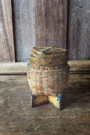 Thai bamboo sticky rice. Thai bamboo sticky rice container on wooden background.の写真素材