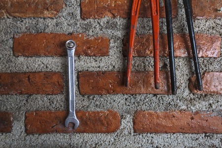 Two pincers on the wall block background.の写真素材