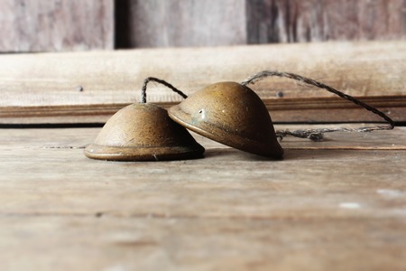 Ronze cymbals castanets Thai asian music percussion instrument on wooden background.の写真素材