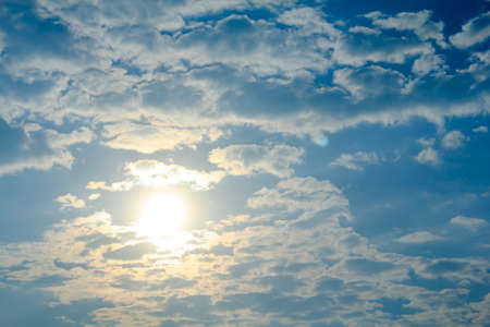 Blue sky background with tiny white cloud and sunの写真素材