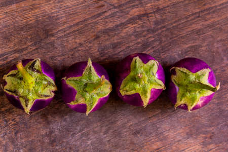 Purple Eggplant. Fresh purple eggplants on a wooden background