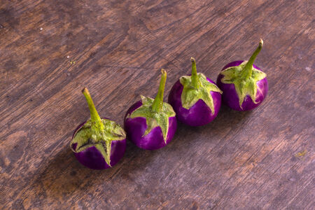 Purple Eggplant. Fresh purple eggplants on a wooden backgroundの写真素材