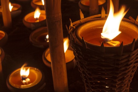 Closeup Group of burning candles in thai style.の写真素材