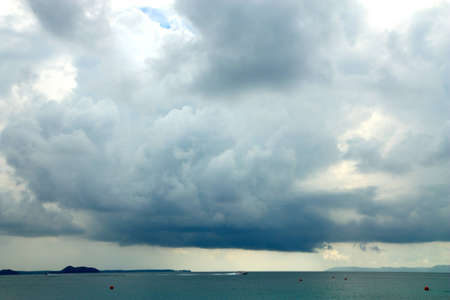 Small boat big cloudの写真素材