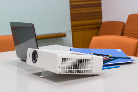 projector connected to Laptop with file folder on the table in a meeting room, Business Concept.の写真素材