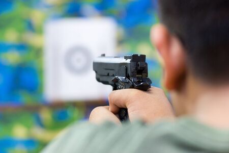 Blurred Image - Man practicing shooting in the amusement park.の写真素材