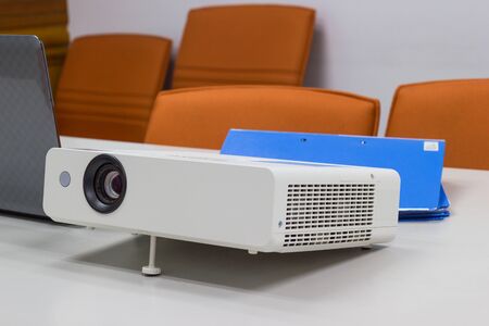 projector connected to Laptop with file folder on the table in a meeting room, Business Concept.の写真素材