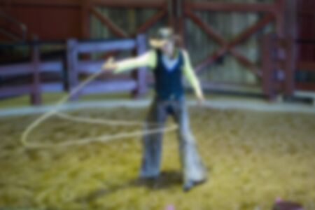Blurred Image - Cowboy spinning lasso for show in parkの写真素材
