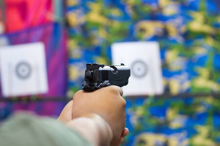 Blurred Image - Man practicing shooting in the amusement park.の写真素材