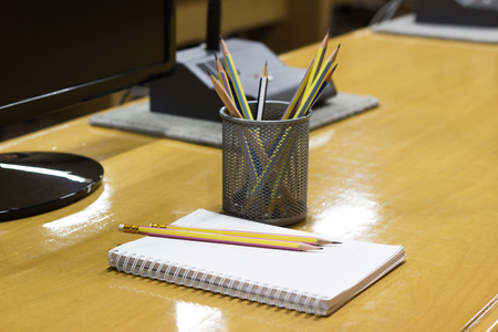 Pencils in cup, Notebook, on Wooden desk at a meeting roomの写真素材