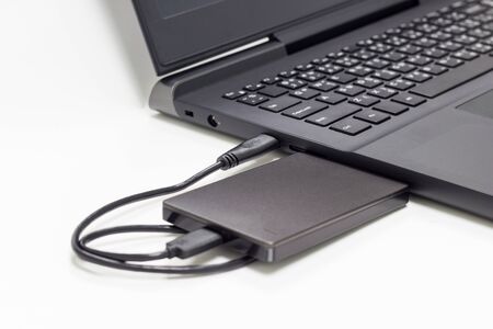 black external hard drive connect to laptop computerの写真素材