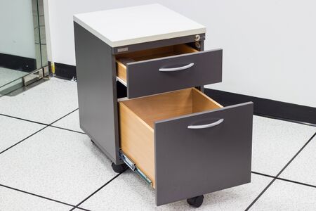file cabinet with open drawer isolated with white background in the officeの写真素材