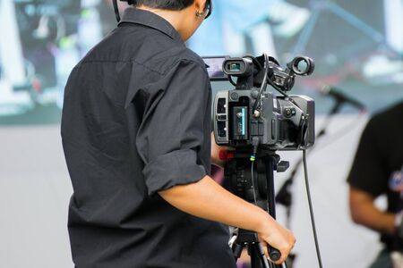 professional cameraman - covering an event to a live and record video at outdoor
