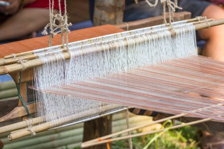 Household Loom weaving - Detail of weaving loom for homemade silk or textile production of Thailandの写真素材