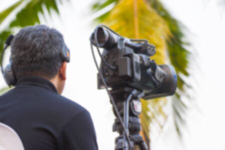 professional cameraman - covering an event to a live and record video at outdoorの写真素材