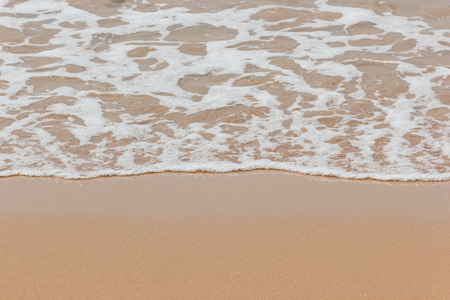 Soft wave of the blue ocean on the seashore of Thailand, copy space on the sand copy space