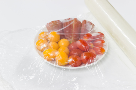 fruits which are wrapped with plastic film preservation on a table isolated white background copy space.の写真素材
