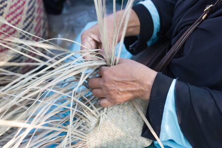 The villagers took bamboo stripes to weave into different forms for daily use utensils of the community people in Bangkok Thailand, Thai handmade product.の写真素材