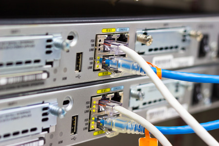 Network switch in rack, network cables connect SFP module port in the Datacenter room, concept...