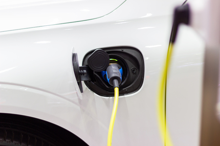 the charging the battery for the car new Automotive Innovations the power supply plugged into an electric car being charged.の写真素材