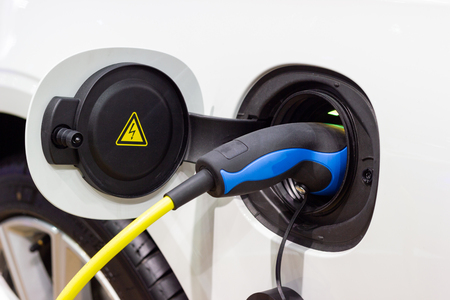 the charging the battery for the car new Automotive Innovations the power supply plugged into an electric car being charged.の写真素材