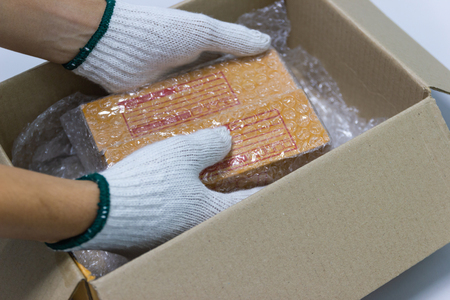 Hand man hold plastic for Packing and protection product cracked or insurance During transit.の写真素材