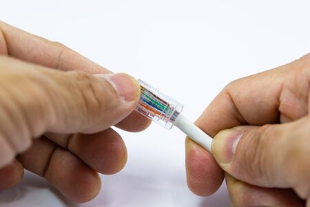 hand of man hold RJ45 with Cable for use Network internet cable, concept network cable connectivity
