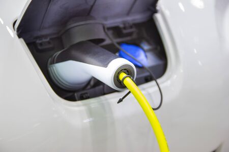 the charging the battery for the car new Automotive Innovations the power supply plugged into an electric car being charged, concept of energy innovation.の写真素材