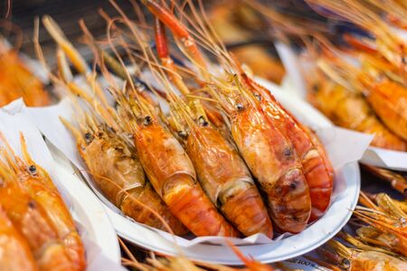 Grilled shrimps of seafood Street food of Thailand on the table in market of Bangkok Thailandの写真素材