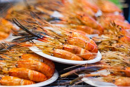 Grilled shrimps of seafood Street food of Thailand on the table in market of Bangkok Thailandの写真素材