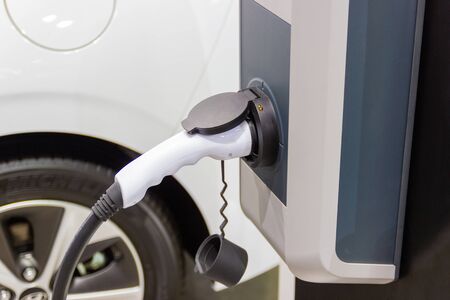 the charging the battery for the car new Automotive Innovations the power supply plugged into an electric car being charged.の写真素材