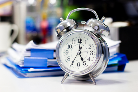 clock on work desk in the office Time of businessman working conceptsの写真素材