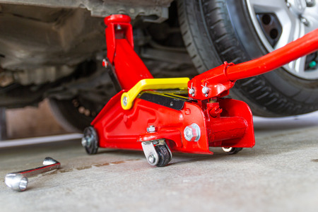 red tool jack lift car for repair check Maintenance of carsの写真素材