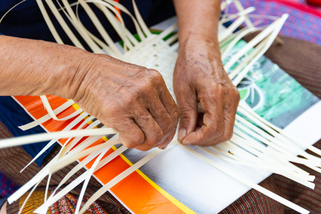 The villagers took bamboo stripes to weave into different forms for daily use utensils of the community people in Bangkok Thailand, Thai handmade product.の写真素材