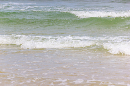 Close up detail of the sea waves washing ashore at the beach Asia Thailandの写真素材