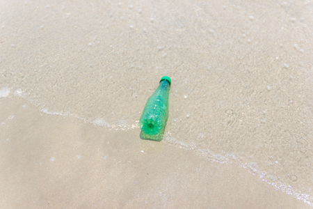 garbage and plastic bottles and dirty waste on a beach Asia Thailand environmental protection concept.の写真素材