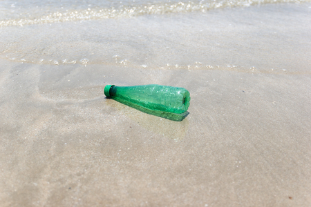 garbage and plastic bottles and dirty waste on a beach Asia Thailand environmental protection concept.の写真素材