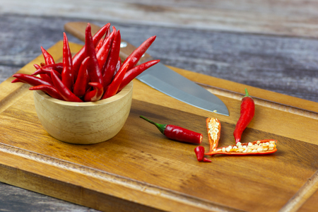 Chili - The pepper plants to the nature of the sphere of the long spikes and knife on woodの写真素材