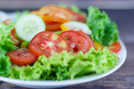 Close up A green salad is a dish consisting of a mixture of small usually Green leafy vegetables with tomatoの写真素材