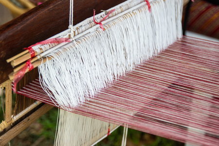 Weaving equipment Household weaving - Detail of weaving loom for homemade silk Used for silk weaving or textile production of Thailandの写真素材