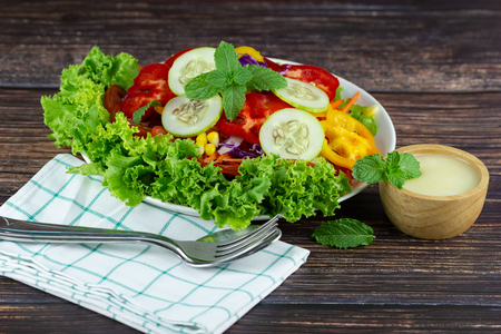 Close up A green salad is a dish consisting of a mixture of small usually Green leafy vegetables with tomatoの写真素材