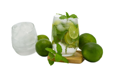 mojito cocktail with lime and mint in glass for hot summer days and good for health isolated whiteの写真素材