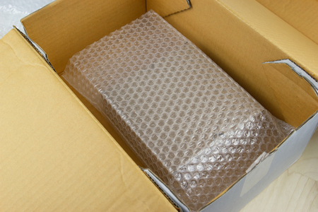 Bubbles covering the box by plastic wrap for protection product cracked  or insurance During transit -isolated white backgroundの写真素材