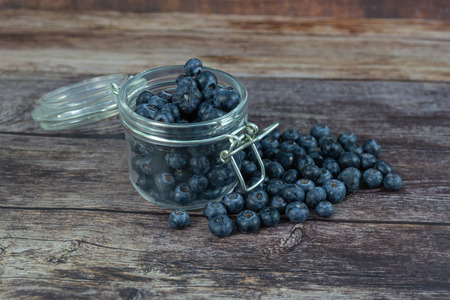 Closeup Detail Blueberries in fresh organic yogurt in glass on wooden tablesの写真素材