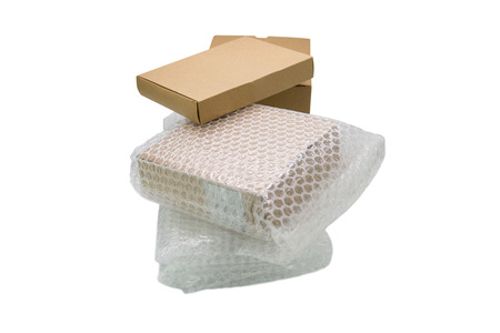 Bubbles covering the box by plastic wrap for protection product cracked  or insurance During transit -isolated white backgroundの写真素材