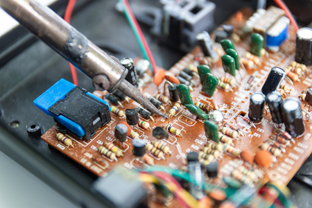 soldering iron for repairing electronic of the computer circuit board concept technology of computer...