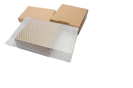Bubbles covering the box by bubble wrap for protection product cracked  or insurance During transit -isolated white background copy spaceの写真素材