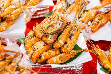 Grilled shrimps of seafood Street food of Thailand on the table in market of Bangkok Thailandの写真素材