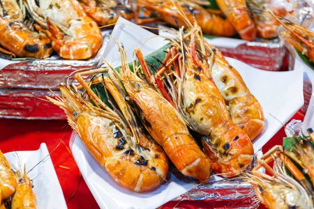 Grilled shrimps of seafood Street food of Thailand on the table in market of Bangkok Thailandの写真素材